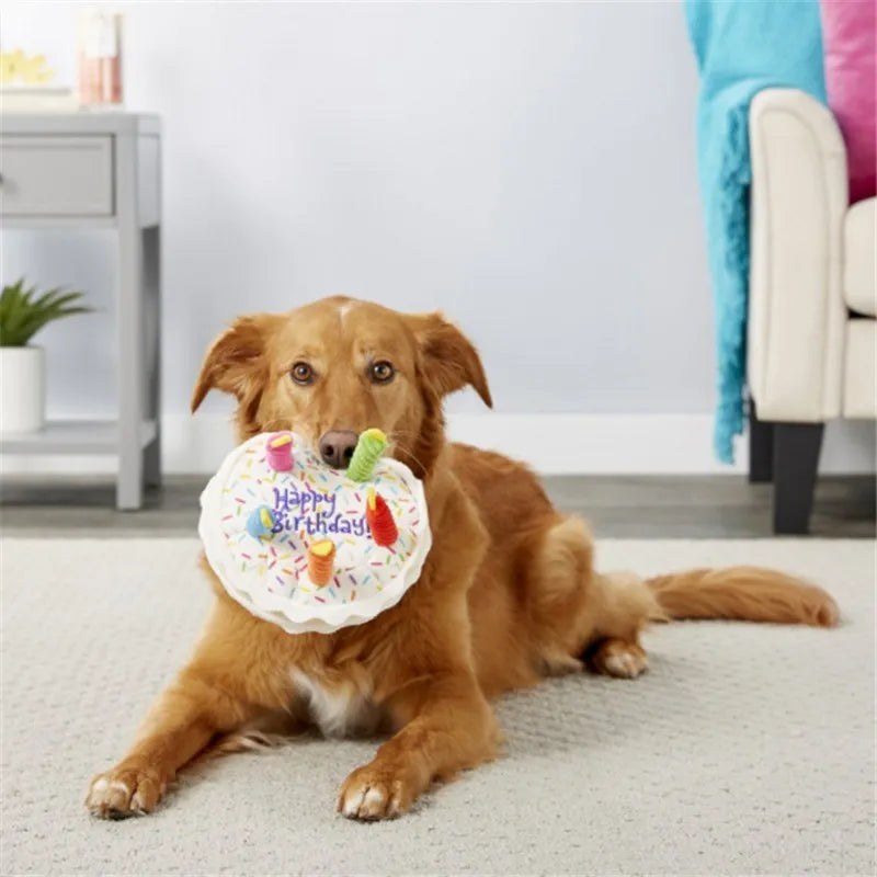 Dog holding birthday cake soft toy