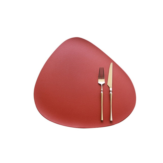 Red leather look placemat with knife and fork