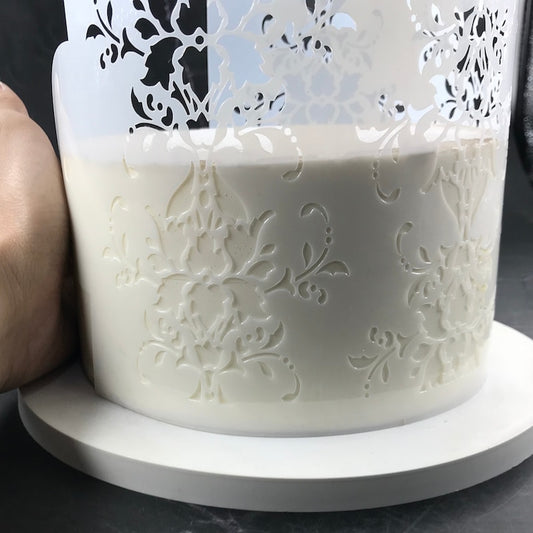 Cake stencil being used on a cake 