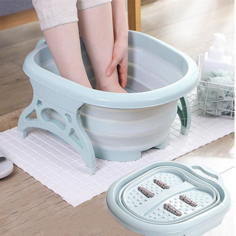 aqua foldable foot massager with a human's feet in it