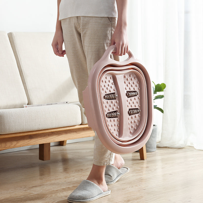 Pink foldable foot massager being carried by a human