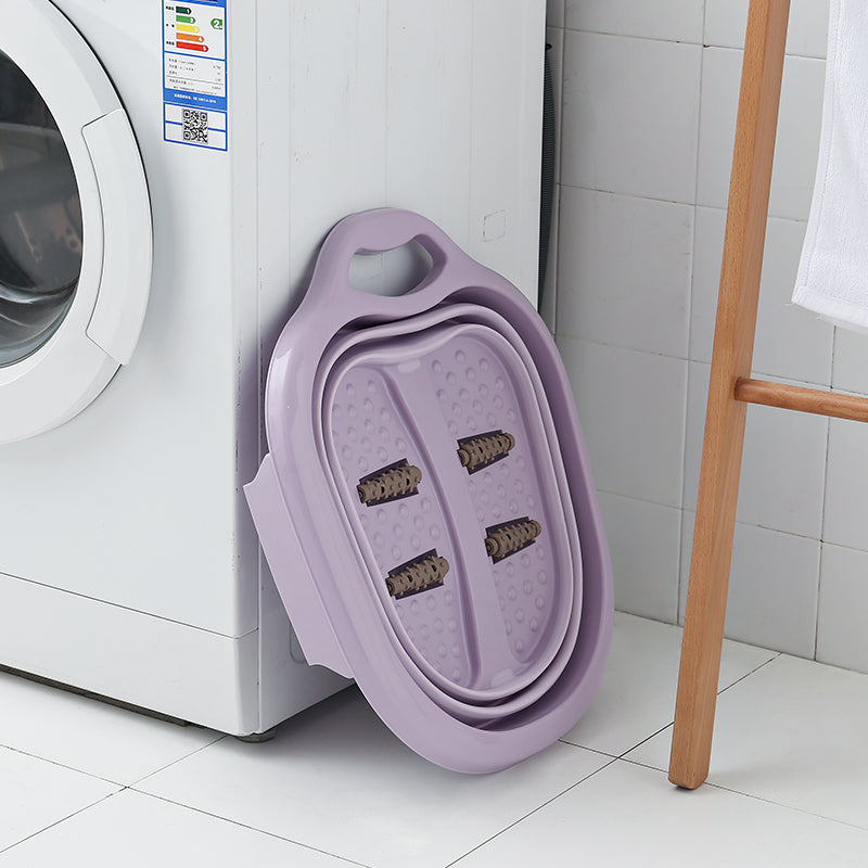 Purple foldable foot massager resting on a washing machine